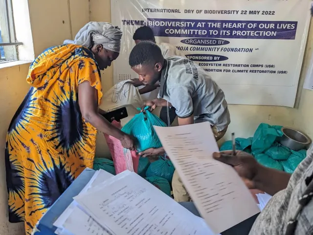 Members of the UCF seed bank with stored bean and maize seed in Nakivale